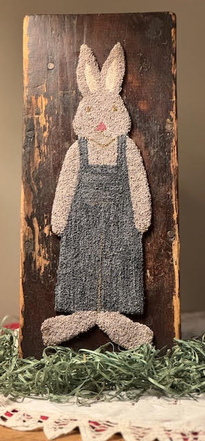 Punch needle rabbit in overalls mounted to an antique step stool